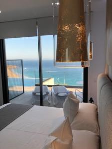 a bedroom with a bed and a view of the ocean at Villa El Buzo in Zahara de los Atunes