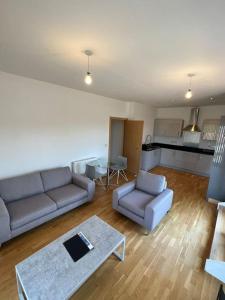 sala de estar con 2 sofás y cocina en Modern 2 bed flat with balcony, en Southend-on-Sea