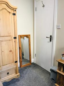 a hallway with a mirror next to a door at Bed for the night, Close to Beach, Shops , Train in St. Leonards