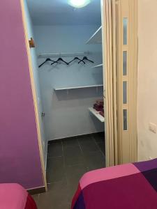 a bedroom with a purple bed and a closet at Violet 27 in Florence