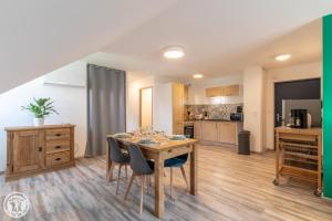 a kitchen and dining room with a table and chairs at Gite Annecy 201- Au Royaume des Castors - Appt 201 in Doussard