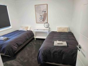 מיטה או מיטות בחדר ב-Brand New Modern 4 Bedroom Home