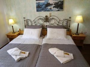 En eller flere senge i et værelse på Nikos Asklipios Paros