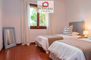 a hotel room with two beds and a window at La Masia de la Fosca in Palamós +31 photos