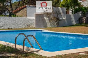 a swimming pool with a sign that reads imperial philippines at La Masia de la Fosca in Palamós