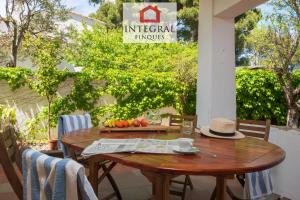 a wooden table on a patio with a sign on it at La Masia de la Fosca in Palamós