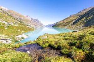 a view of a mountain lake in a valley at Wellnesshotel Schweizerhof in Saas-Fee