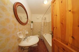 a bathroom with a sink and a mirror and a tub at Residenza CRB 38 by Wonderful Italy in Manerba del Garda +32 photos