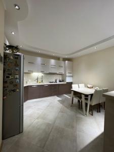 a kitchen and dining room with a table and a refrigerator at Lost in Tbilisi in Tbilisi City
