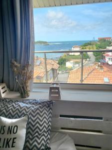 a room with a large window with a view of the ocean at Penthouse Apartments PERLA, Vasiliko in Tsarevo