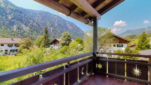 a balcony with a view of a mountain at Fischer`s Postresidenzen Ettal in Ettal