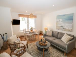 a living room with a couch and a table at Seaspray in Teignmouth