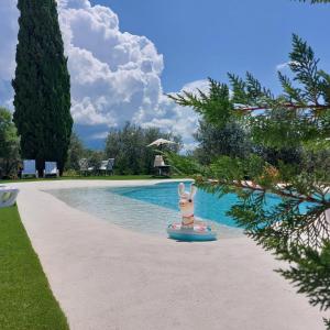 a toy bunny on a raft in front of a swimming pool at Apartments Casa Tijola in Sečovlje