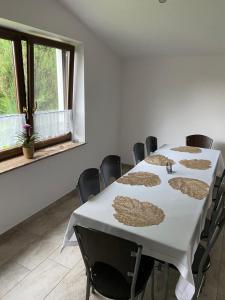 a room with a table and chairs and a window at Dom Wiktor 