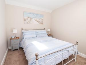 a bedroom with a bed and two night stands at Olive Cottage in York