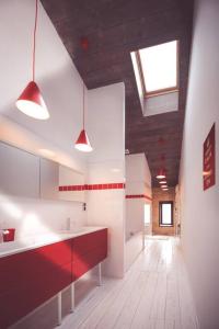 a kitchen with red and white cabinets and a window at Splendide Chai 700 m2 Bordeaux in Bordeaux +12 photos