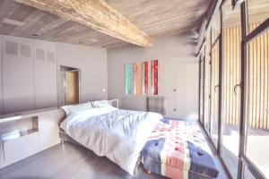 a bedroom with a large bed and a large window at Splendide Chai 700 m2 Bordeaux in Bordeaux