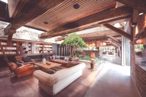 a living room with a couch and a table at Splendide Chai 700 m2 Bordeaux in Bordeaux