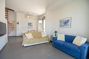 a living room with two blue couches and a tv at Athens city center maisonette for 3 persons by MPS in Athens