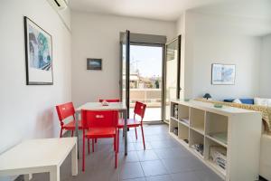 a dining room with a table and red chairs at Athens city center maisonette for 3 persons by MPS in Athens