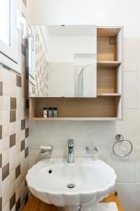 a bathroom with a white sink and a mirror at My Kythnos House in Kithnos +41 photos