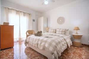 a white bedroom with a bed and a window at CITY CENTER AND NEXT TO THE BEACH 3 BEDROOMs in Málaga