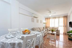 comedor y sala de estar con mesa y sillas en CITY CENTER AND NEXT TO THE BEACH 3 BEDROOMs en Málaga