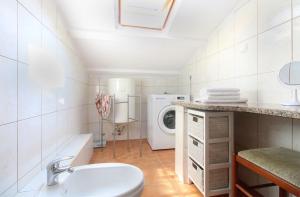 a bathroom with a sink and a washing machine at Apartment Nada 1451 in Fažana +49 photos