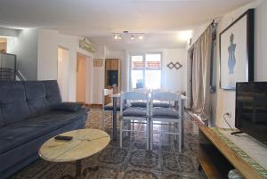 a living room with a couch and a table at Apartment Nada 1451 in Fažana