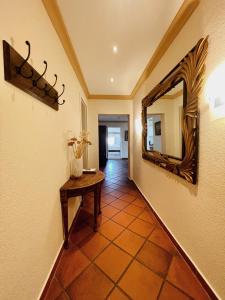 a hallway with a mirror and a table at Apartment Josephine in Lübeck