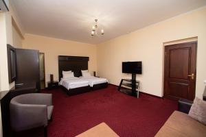 a hotel room with two beds and a television at 14 Floor Hotel in Yerevan