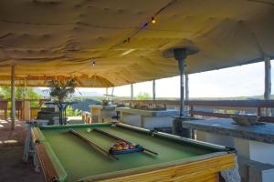 a pool table on a deck with a canopy at Rainforest Ridge Eco Resort in The Crags