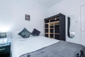 a bedroom with a white bed and a window at 65 inch TV in Modern 2 Bed Hideaway in Bradford