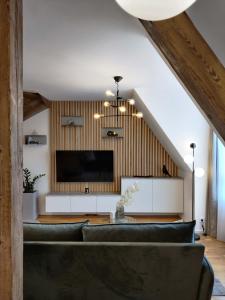 a living room with a couch and a flat screen tv at Old Town Museum Apartment in Liberec