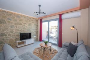 A television and/or entertainment centre at Gold Olive Suites by "elite"