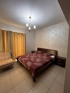 a bedroom with a bed and a chair in it at Nice tow bedrooms by snake pool in talapay in Aqaba