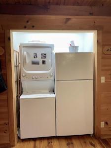 a white refrigerator and a microwave in a room at Peaceful Tellico View Home with Private Hot Tub in Tellico Plains