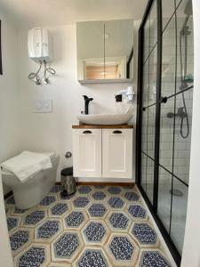 a bathroom with a sink and a toilet and a shower at Lavira Tiny House Village in Bogazici