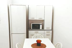 a kitchen with a table with a cup on it at Apartamentos Carrillo 5 in Santa Cruz de Tenerife