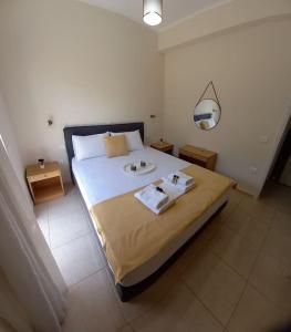 a bedroom with a bed with two towels on it at Olivo Nydri in Nydri