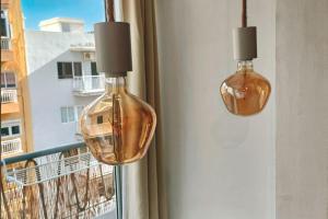two glass lights hanging from a window with a view at Apartamentos Carrillo 5 in Santa Cruz de Tenerife