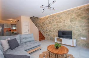 A television and/or entertainment centre at Gold Olive Suites by "elite"