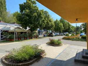 a view of a street with trees and plants at Móló Apartmanház in Balatonszemes