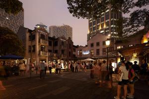 a group of people walking on a city street at night at Courtyard by Marriott Shanghai Central in Shanghai