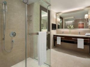 a bathroom with a shower and a sink at Shangri-La Kuala Lumpur in Kuala Lumpur