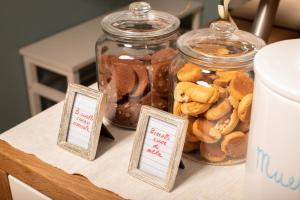 a table with two jars of nuts and cookies at Hotel Villa Maris in Rimini