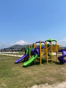 a playground with a slide in a park at Lavira Tiny House Village in Bogazici