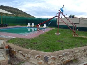 a playground with a slide next to a pool at Zithei Lodge in Lombardskop Settlement