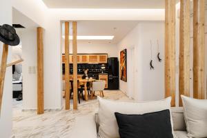 a living room with a couch and a table at Naxos Petite In Town in Naxos Chora