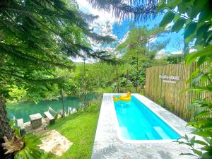 a swimming pool in a backyard with a toy in the middle at Por jai’s House in Campson